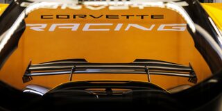 Side View of a Yellow and Black 2026 Corvette CX.R Racing on a Track