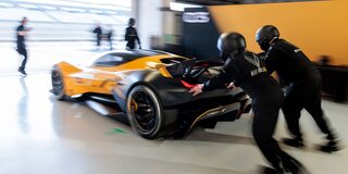 Side View of a Yellow and Black 2026 Corvette CX.R Racing on a Track