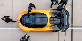 Side View of a Yellow and Black 2026 Corvette CX.R Racing on a Track