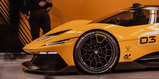 Side View of a Yellow and Black 2026 Corvette CX.R Racing on a Track