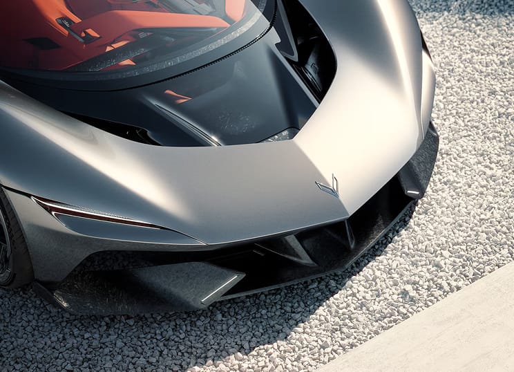Three-quarter view of the front section of Corvette CX in a black metallic finish, parked on silver-grey tarmac.