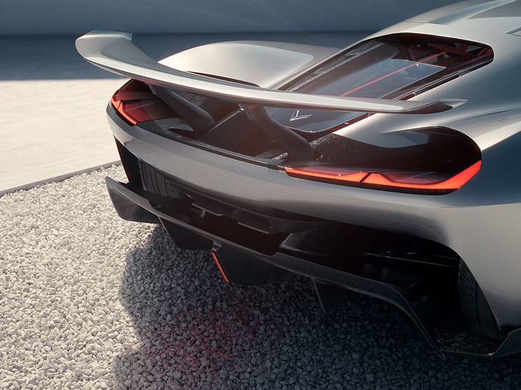 Three-quarter rear view of Corvette CX in a black metallic finish, parked on silver-grey tarmac.