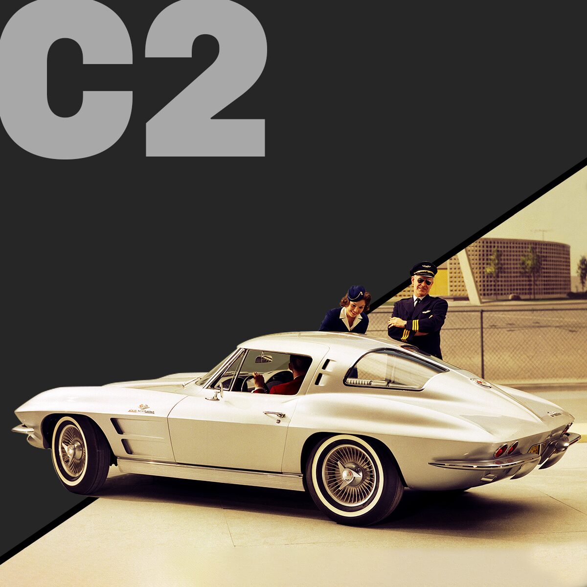 Three-quarter rear view of a silver Corvette C2 coupé, parked outside with airline crew talking to the driver.  