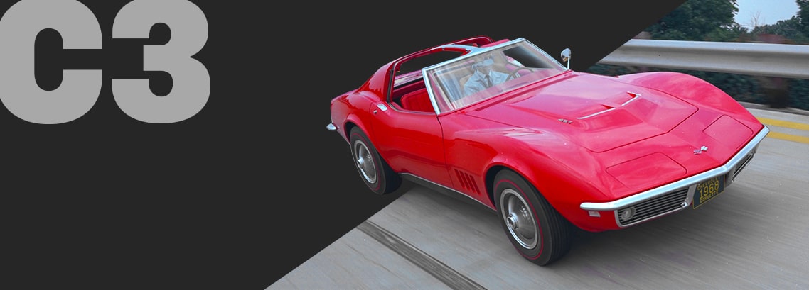 Three-quarter view of a scarlet Corvette C3 convertible, burning rubber on a highway.