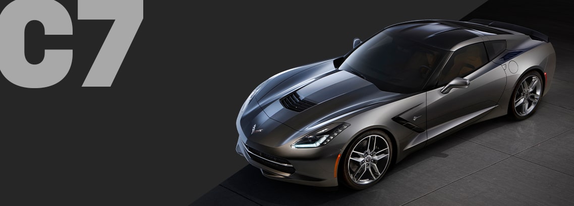 Three-quarter view of a black Corvette C7 coupé, parked in a showroom.