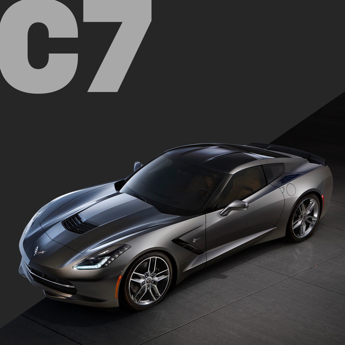 Three-quarter view of a black Corvette C7 coupé, parked in a showroom.