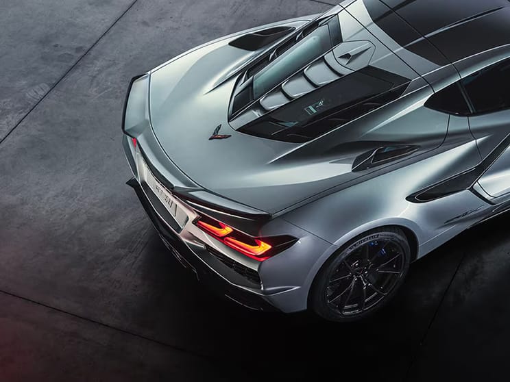 Aerial three-quarter rear view of the back section of a Chevy Corvette ZR1X hypercar, finished in Blade Silver Metallic.