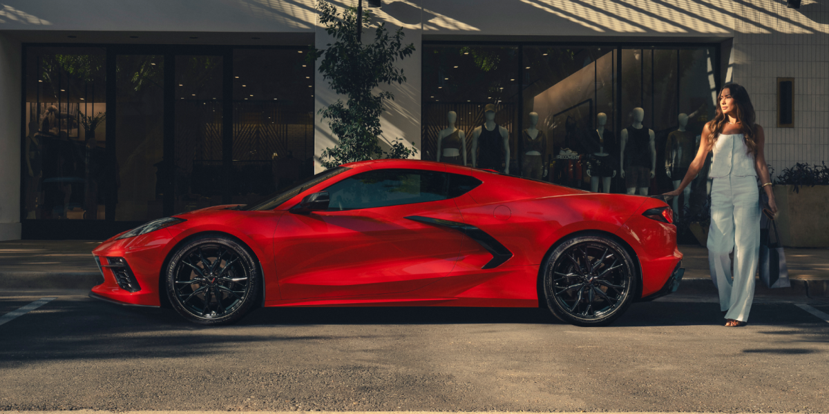 Side View of a 2025 Red Stingray on a Shade with a Girl behind It