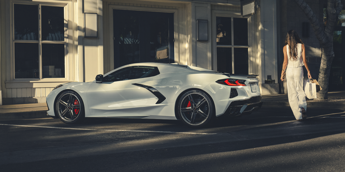 Woman Walking Up to a 2025 Corvette Stingray with Shopping Bags