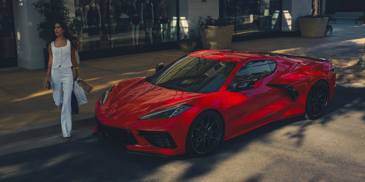 Woman Walking Up to a 2025 Corvette Stingray with Shopping Bags