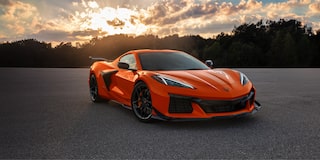 Three Quarters View of an Orange 2025 Chevy Corvette Z06 with a Setting Sun Behind It