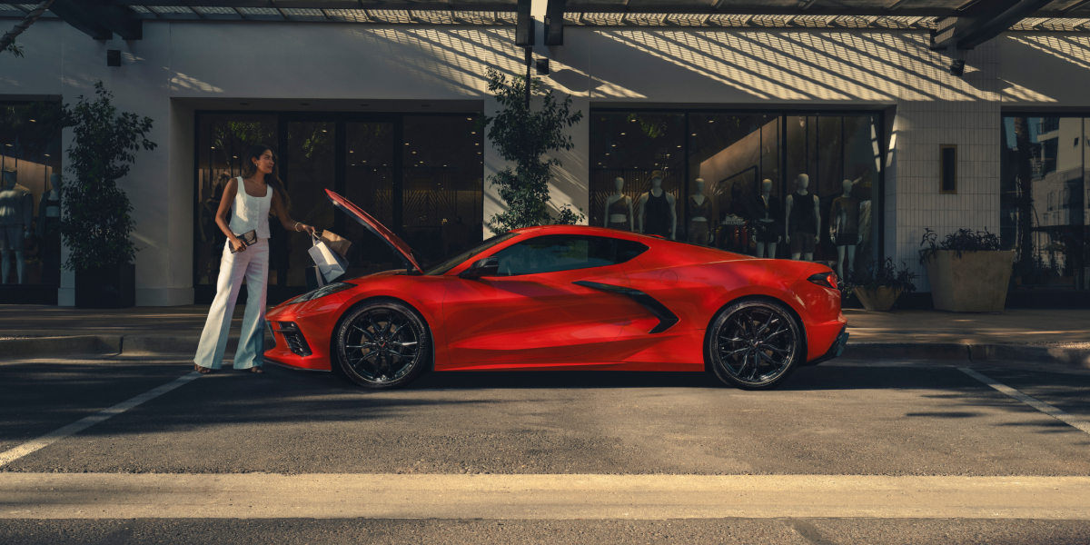 A Woman Loading Her Shopping Bags into the Front Trunk of the 2026 Chevy Corvette Stingray