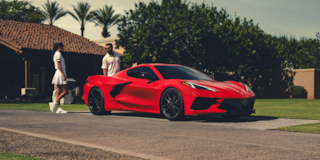 A Couple in Tennis Clothes Walking Toward Their 2026 Chevy Corvette Stingray