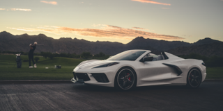 2026 Chevy Corvette Stingray Parked Near a Man Hitting Golf Balls