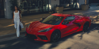 A Woman Walking Toward Her Parked 2026 Chevy Corvette Stingray