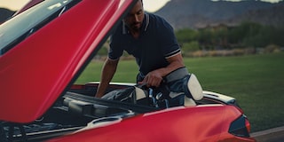Man Loading Golf Equipment into the Trunk of the 2026 Chevy Corvette Stingray